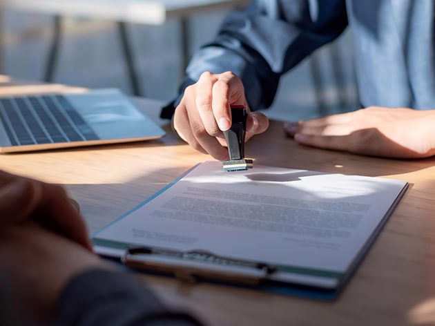 Man stamping paper for approval